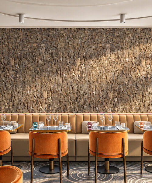 Roccia HDF - 1 7/64"(28mm) - Cork Wall Panels (WRocc28) Roccia 28mm brown 3D cork wall panels with natural bark texture creating a decorative feature wall in an upscale restaurant with orange velvet chairs and booth seating. Copy