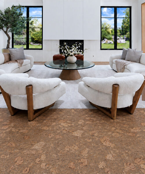 Rococo - 1/2" (12mm) - Cork Floating (FRoco12) Warm amber Rococo natural cork flooring frames rounded ivory seating and a glass coffee table.