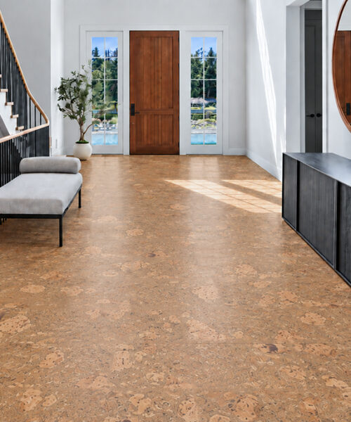 Rococo - 1/2" (12mm) - Cork Floating (FRoco12) Rococo natural cork floor planks cover a sunlit entryway beside black railings and a modern console.