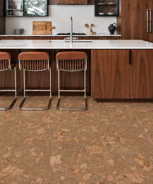 Rococo - 1/2" (12mm) - Cork Floating (FRoco12) Warm Rococo floating cork flooring surrounds a walnut kitchen island with three leather counter stools.