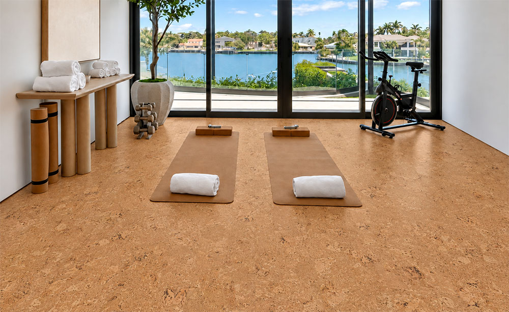 Salami - 1/2" (12mm) - Cork Floating (FSal12) Comfortable Salami cork flooring covers a waterfront exercise room with yoga mats, weights, and stationary bike.