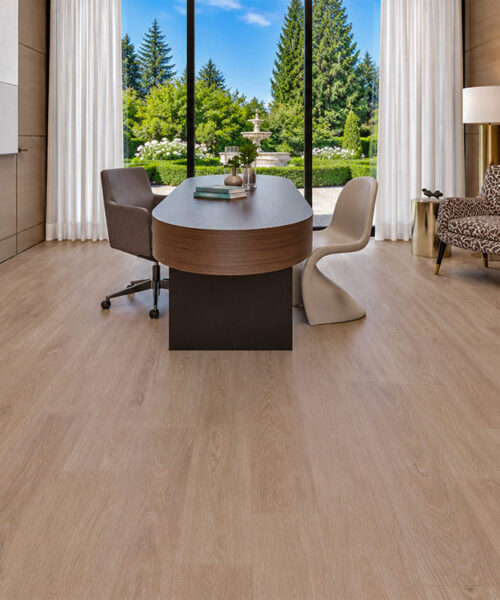 Sandstorm - 7/16" (11mm) - Swiss Design Cork Floating (FSan11) Light beige Sandstorm cork floating floor with natural wood grain in an elegant office featuring a curved desk and floor-to-ceiling garden window.