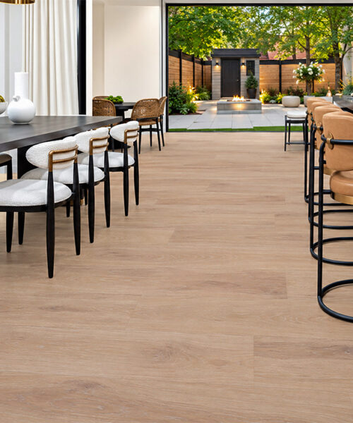 Sandstorm - 7/16" (11mm) - Swiss Design Cork Floating (FSan11) Sandstorm cream-tan hardwood-look cork flooring connects a contemporary dining area and marble home bar overlooking a landscaped courtyard.