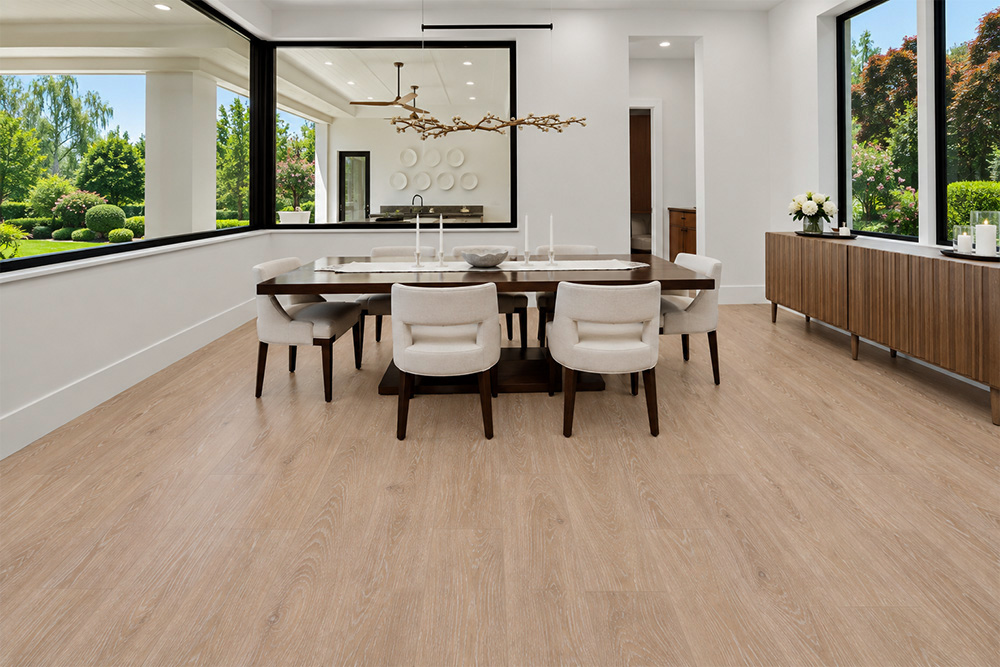Sandstorm - 7/16" (11mm) - Swiss Design Cork Floating (FSan11) Sustainable Sandstorm cork flooring with soft tan wood grain brightens a modern dining room with large windows and a sculptural chandelier.