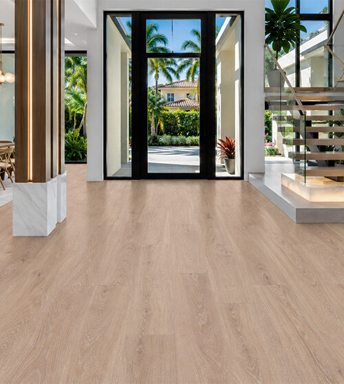 Warm sand-colored cork flooring with subtle hardwood grain in a bright entryway featuring glass doors, floating stairs, and a live-edge console.