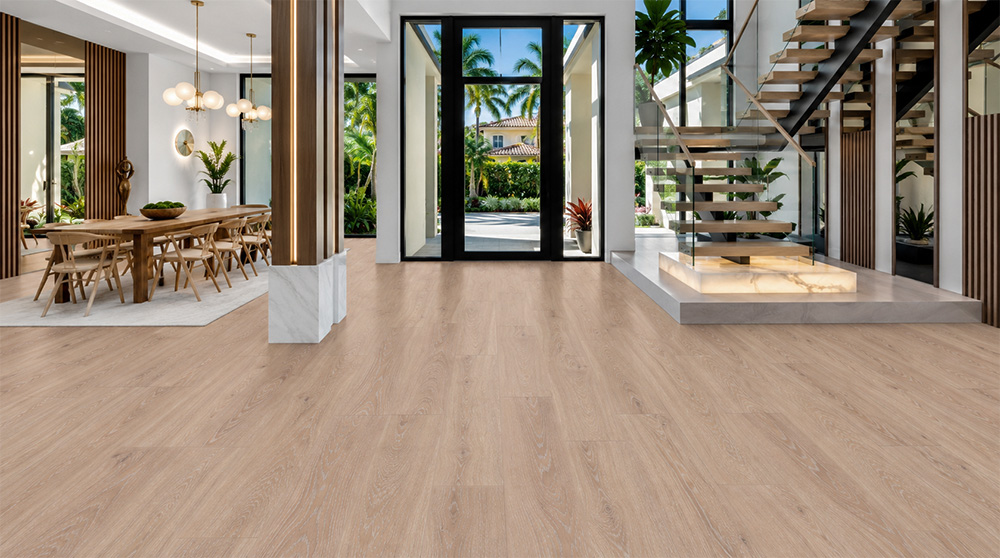 Sandstorm - 7/16" (11mm) - Swiss Design Cork Floating (FSan11) Warm sand-colored cork flooring with subtle hardwood grain in a bright entryway featuring glass doors, floating stairs, and a live-edge console.