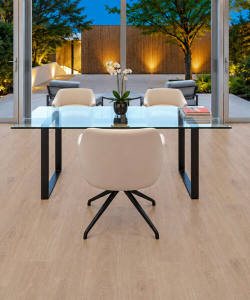 Sandstorm - 7/16" (11mm) - Swiss Design Cork Floating (FSan11) Eco-friendly Sandstorm wood-look cork floating flooring in a garden-view office with a glass desk and contemporary black stone fireplace.