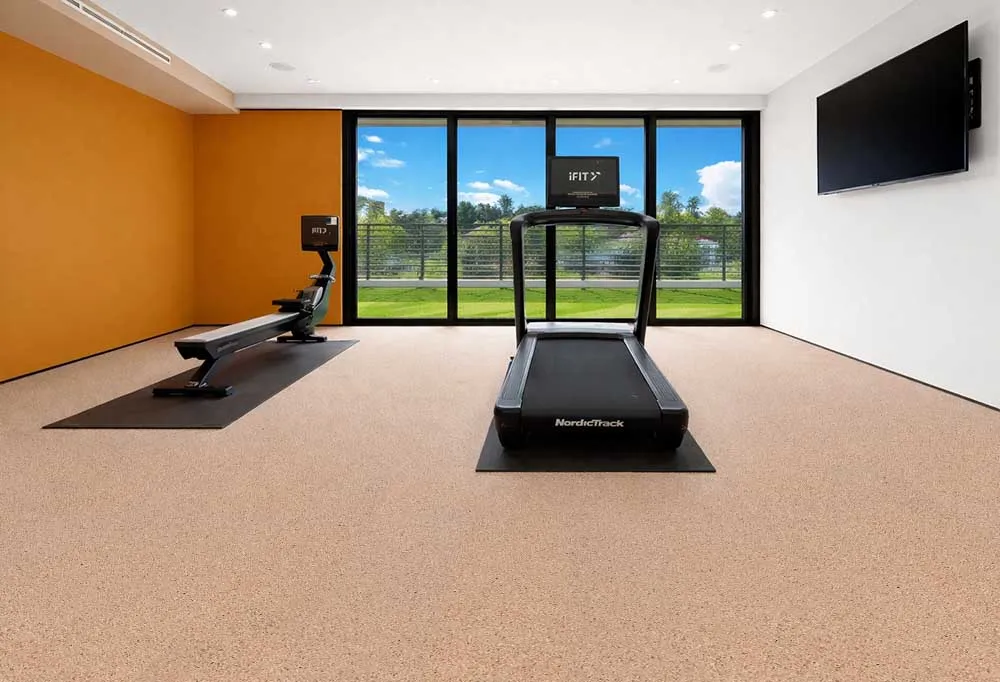 Seaside - 7/16" (11mm) - Swiss Real Cork Floating (FSea11) Seaside cork flooring installed in a home gym, providing resilient surface, sound absorption, and workout comfort.