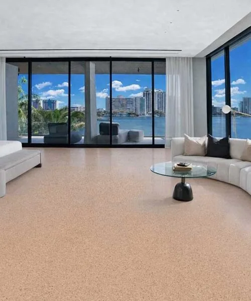Seaside cork flooring in a luxury waterfront bedroom offering natural warmth, quiet comfort, and modern coastal design.