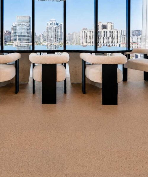 Natural-toned Seaside floating cork flooring complements panoramic windows in a modern high-rise dining area.