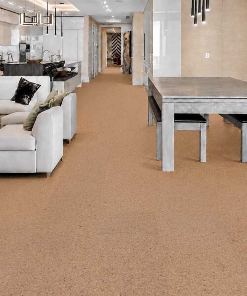 Eco-friendly Seaside cork flooring connects a modern living room, dining area, and kitchen.