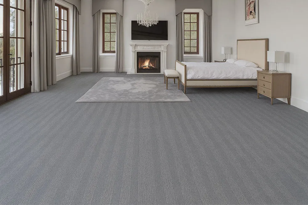 Spacious bedroom with Swiss Serpent Luxe leather floating floors, soft gray finish adding sophistication to a warm, inviting retreat.