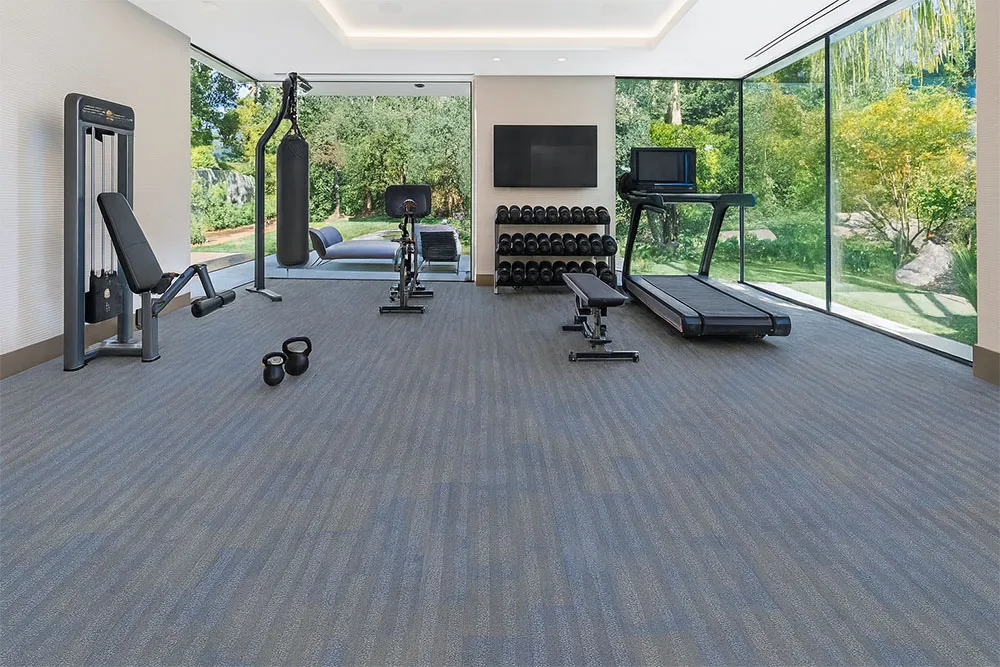 Luxury home fitness room showcasing Swiss Serpent Luxe leather flooring, resilient blue-gray surface ideal for workouts and training.