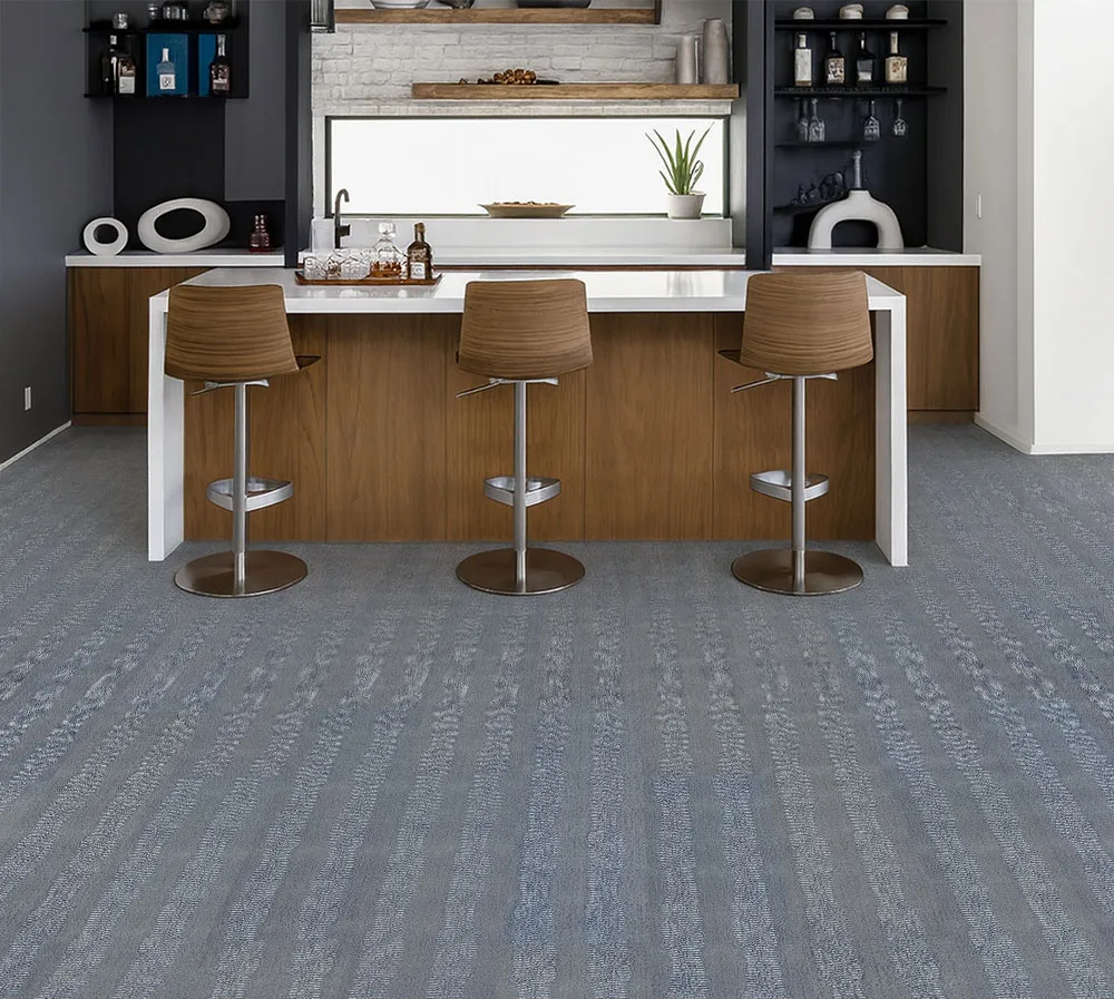 Stylish kitchen bar with Serpent Luxe Swiss leather flooring, elegant gray-blue tones creating a durable foundation for wood cabinetry.