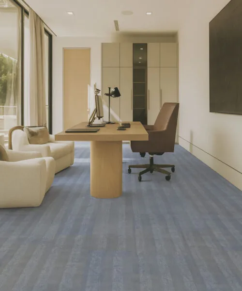 Modern office interior featuring Serpent Luxe Swiss leather floating flooring, blue-gray design balancing comfort and professional style.