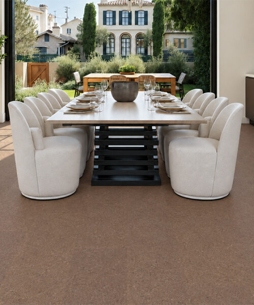 Shoreline - 25/64" (10mm) - Cork Floating (FShol10) Shoreline 10mm natural mid-brown floating cork flooring with subtle speckling in a garden-facing dining room.
