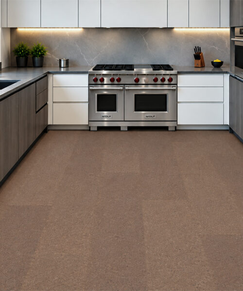 Shoreline - 25/64" (10mm) - Cork Floating (FShol10) Shoreline 10mm natural mid-brown cork floor planks with subtle speckling in a stainless-steel kitchen.