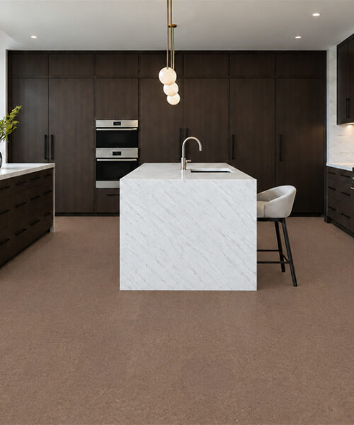 Shoreline - 25/64" (10mm) - Cork Floating (FShol10) Shoreline 10mm natural mid-brown floating cork flooring complements dark cabinetry and a white marble island.