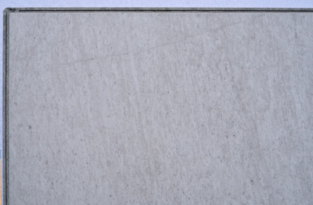 Snowstone - 19/64" (7.5mm) - Swiss Techslate (MCSnows7.5) Snowstone Swiss Techslate floating flooring featuring a white limestone stone look with soft grey undertones and subtle natural mineral texture