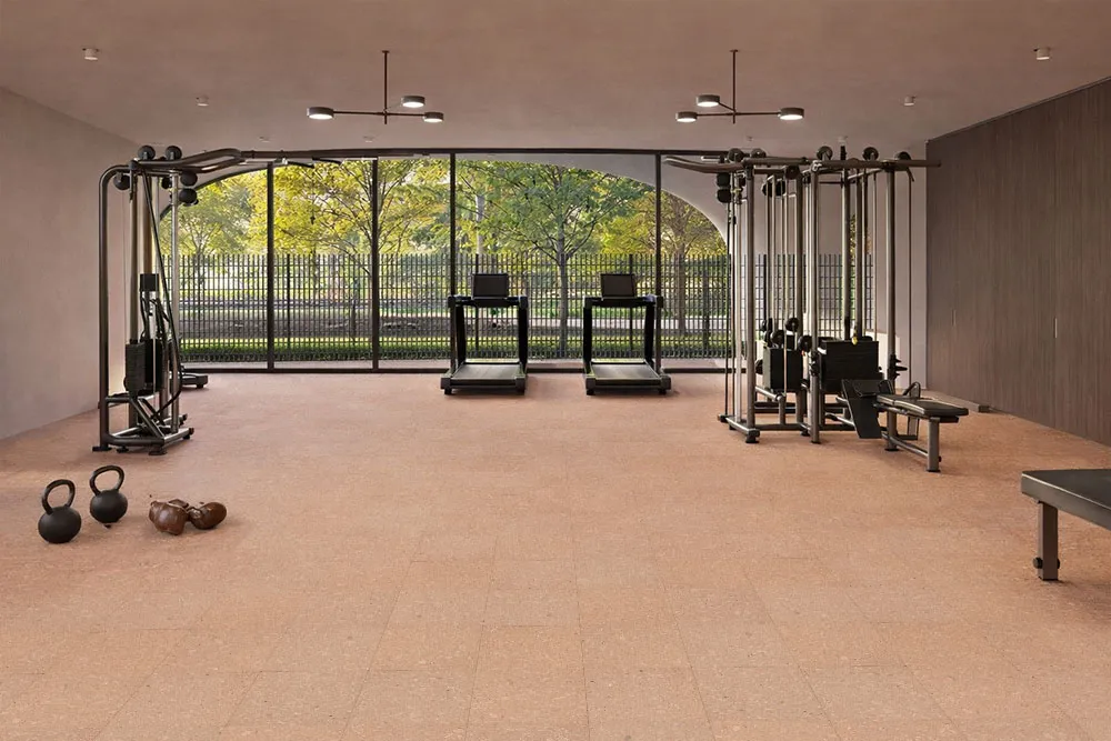 Solara solid massive glue down cork tiles creating a comfortable and quiet fitness space with natural cork flooring under exercise equipment.