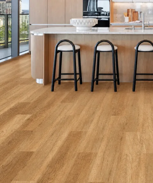 Spanish Cedar golden-brown cork flooring surrounding a large island in a contemporary kitchen.