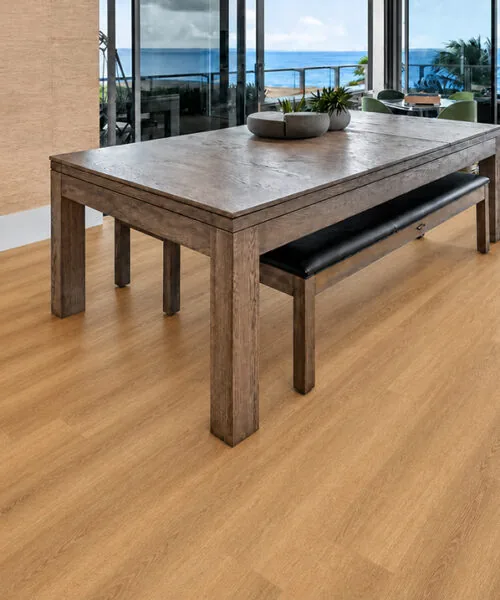 Spanish Cedar - 13/32" (10.5mm) - Design Cork Floating (FSC10.5) Spanish Cedar natural wood-look cork flooring in a waterfront living room with floor-to-ceiling windows.