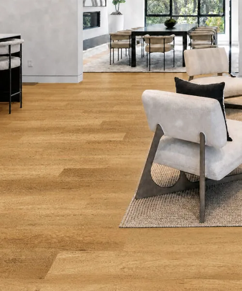 Spanish Cedar - 13/32" (10.5mm) - Design Cork Floating (FSC10.5) Spanish Cedar golden-tan cork plank flooring connecting an open-concept living room, kitchen, and dining area.