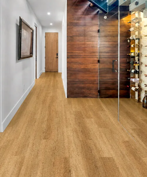 Spanish Cedar - 13/32" (10.5mm) - Design Cork Floating (FSC10.5) Spanish Cedar natural-brown floating cork flooring in a hallway beside a glass-enclosed wine cellar.