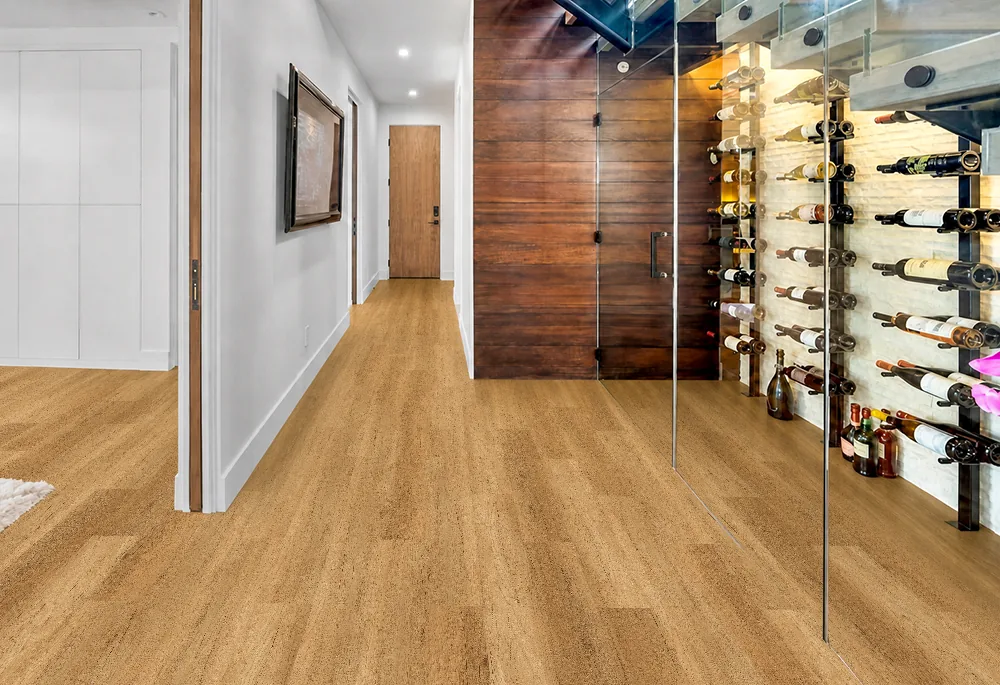 Spanish Cedar - 13/32" (10.5mm) - Design Cork Floating (FSC10.5) Spanish Cedar natural-brown floating cork flooring in a hallway beside a glass-enclosed wine cellar.