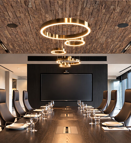 Stacked Stone - 55/64" (22mm) - Acoustic Cork Wall Tile (WSkSt22) Rich brown cork ceiling tiles with dimensional stacked stone patterns bring natural texture to a contemporary corporate boardroom.