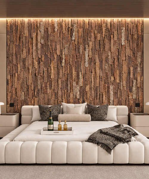 Stacked Stone - 55/64" (22mm) - Acoustic Cork Wall Tile (WSkSt22) Natural cork wall panels in warm brown tones feature a raised vertical stone pattern behind a modern upholstered bed.