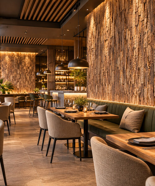 Stacked Stone - 55/64" (22mm) - Acoustic Cork Wall Tile (WSkSt22) Eco-friendly 3D cork wall panels with rustic brown textures and vertical tile arrangement complement a warmly lit restaurant dining area.