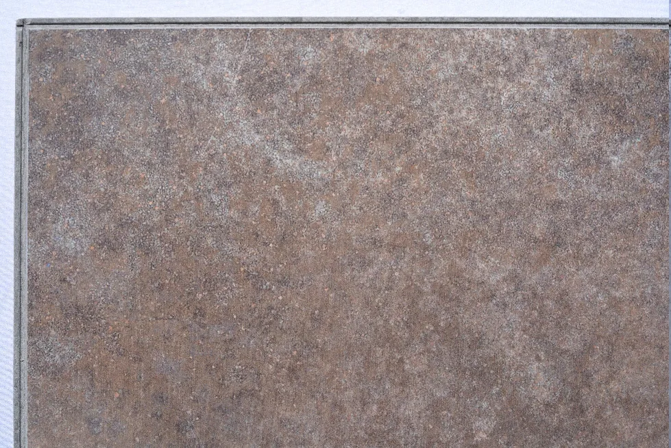 Sunlit Stone - 19/64" (7.5mm) - Swiss Techslate (MSunSt7.5) Sunlit Stone Swiss Techslate flooring featuring warm bronze and grey stone tones with a weathered slate appearance, creating a sophisticated natural stone look for modern and rustic interiors