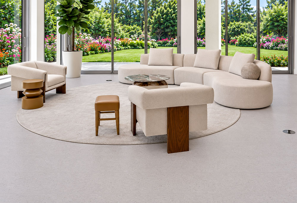Sustainazzo - 25/64" (10mm) - Cork Floating (FSus10) Sustainazzo terrazzo-inspired cork flooring surrounds curved neutral seating in a sunlit living room overlooking gardens.