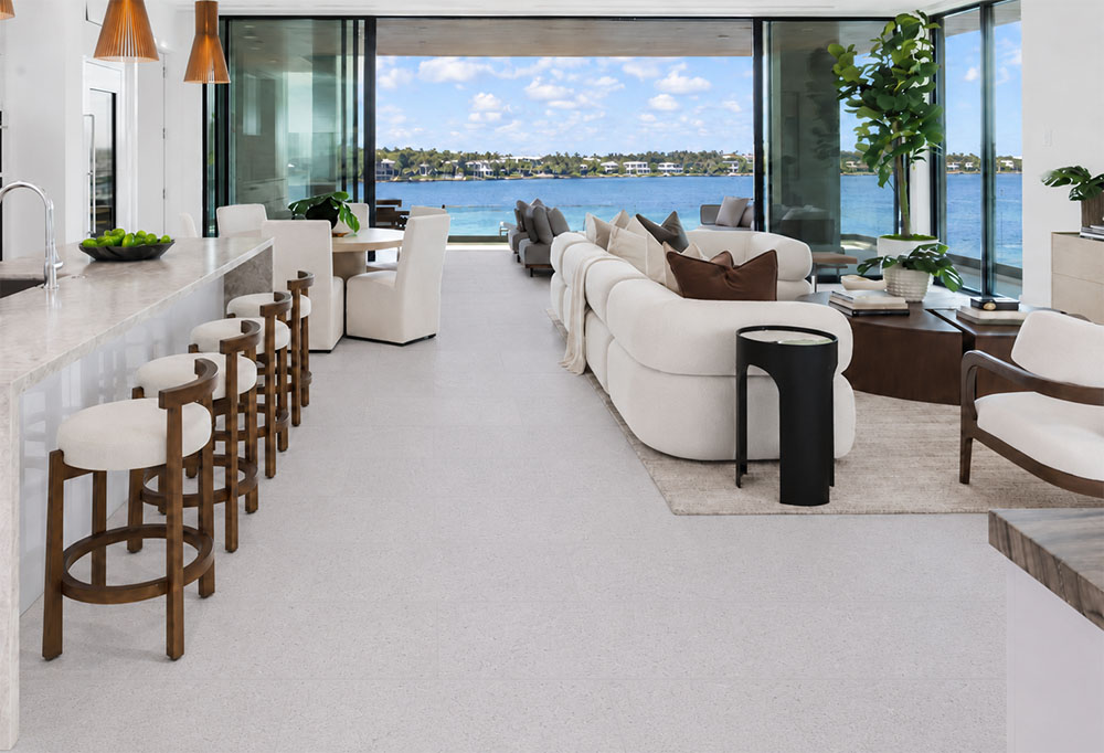 Sustainazzo - 25/64" (10mm) - Cork Floating (FSus10) Sustainazzo 10mm Cork Floating Flooring flows through a waterfront kitchen and living space with white furnishings.