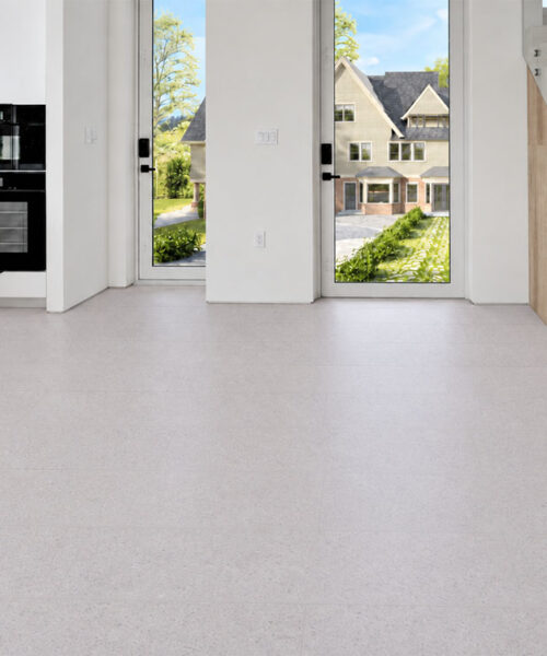 Sustainazzo - 25/64" (10mm) - Cork Floating (FSus10) Sustainazzo pale white cork flooring creates a seamless entryway beside modern cabinetry and a glass staircase.