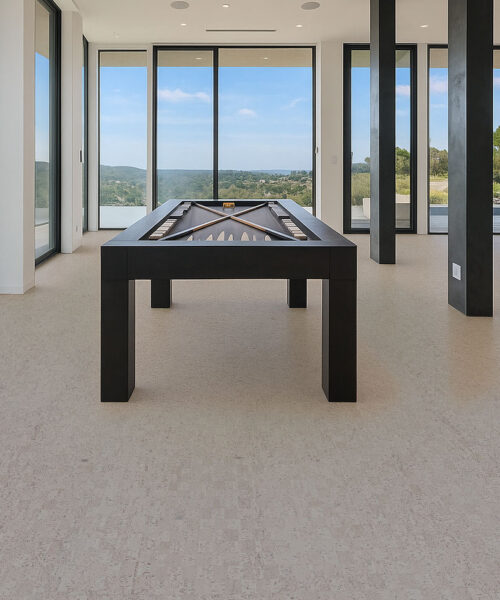 Modular - 7/16" (11mm) - Swiss Real Cork Floating (FMod11) Modern game room with pool table on light gray cork flooring, large windows, and panoramic outdoor views