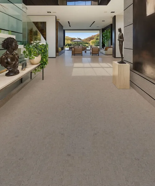 Luxury open hallway with light gray cork flooring, high ceilings, natural light, and contemporary architecture