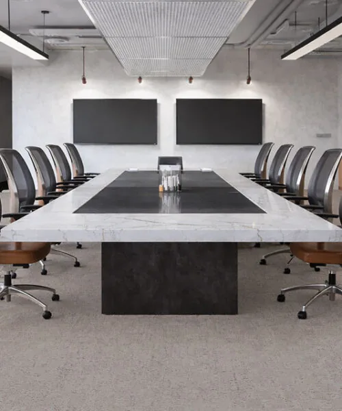 Modern boardroom with long table and chairs on light gray cork flooring, commercial office interior de