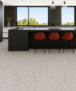 Contemporary kitchen with black island and red bar stools on light gray cork flooring, sleek modern style