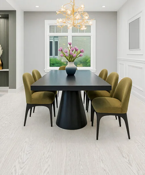 Modern dining room with Swiss Snow Cap real wood floating flooring, featuring a black pedestal table and olive-green chairs in a bright, elegant space.