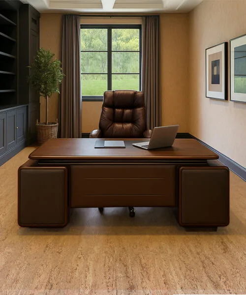 Umber - 1/4" (6mm) - Swiss Cork Glue Down Tile (GUmb6) Modern executive office featuring warm beige cork flooring, a large dark wood desk with leather accents, and a high-back leather chair centered in front of a window. Built-in charcoal cabinetry with shelving lines the left wall, complemented by framed geometric artwork on the right. The natural cork floor adds warmth and acoustic comfort to the elegant workspace.