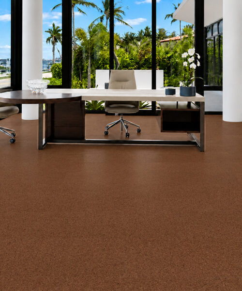 Venetian - 25/64" (10mm) - Cork Floating (FVen10) Venetian 10mm quiet cork flooring in warm brown grounds a tropical-view office with an executive desk.