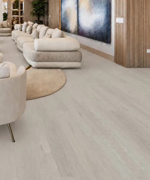 Light Grey Oak - 13/32" (10.5mm) - Design Cork Floating (FLG10.5) Elegant living room with light grey oak floating floor, curved seating, and wood paneling