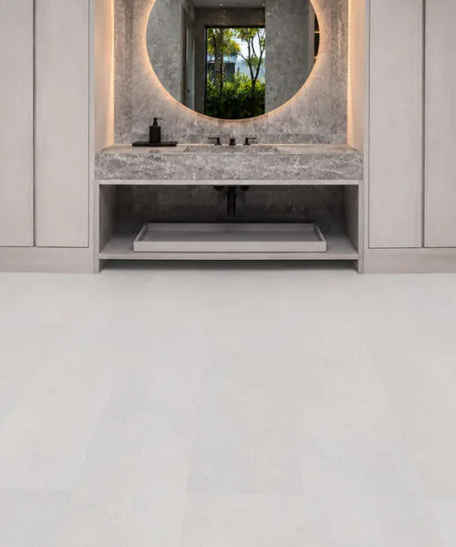 Contemporary hospitality lounge featuring White Leather cork flooring with a soft white leather-look finish, seamless planks, and modern cabinetry.