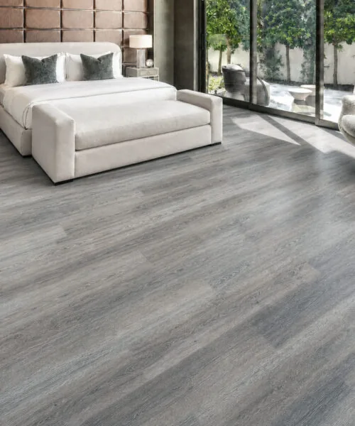 Wild Oak - 13/32" (10.5mm) - Design Cork Floating (FWO10.5) Sunlit contemporary bedroom with textured gray oak-look cork plank flooring.