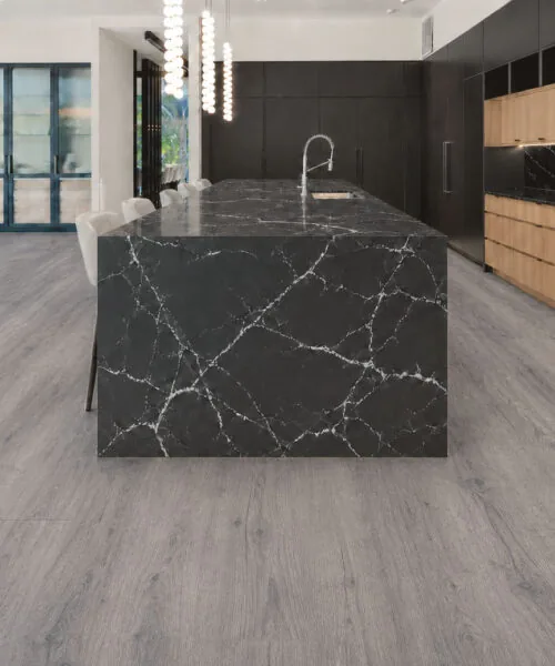 Wild Oak - 13/32" (10.5mm) - Design Cork Floating (FWO10.5) Modern black-and-wood kitchen with wide gray oak-pattern cork floor planks.