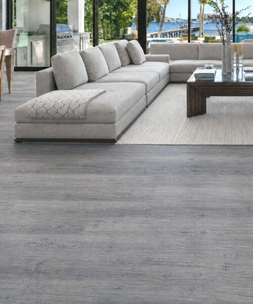 Spacious coastal living room featuring wide-plank gray oak-look cork flooring.