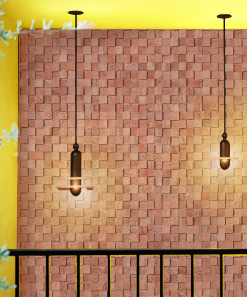 Textured wood cubes cork wall tiles illuminated by pendant lights, highlighting the natural acoustic properties and decorative depth of 3D cork panels.