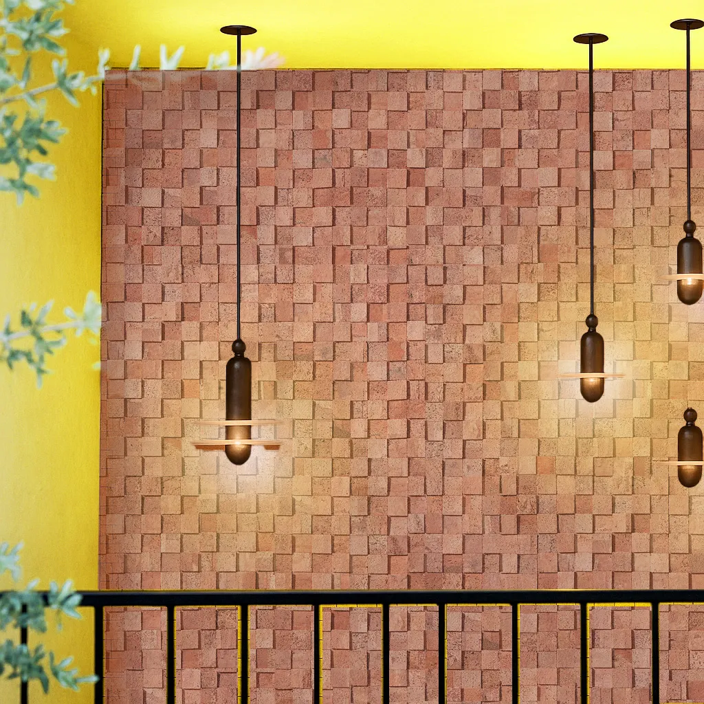 Textured wood cubes cork wall tiles illuminated by pendant lights, highlighting the natural acoustic properties and decorative depth of 3D cork panels.